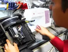 Vacuum repair technician servicing internal components on a workbench in Fort Worth, TX