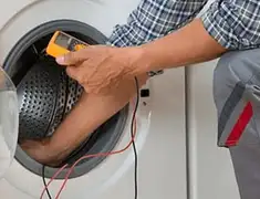 Washing machine repair technician testing a front-load washer with diagnostic tools in Fort Worth, TX